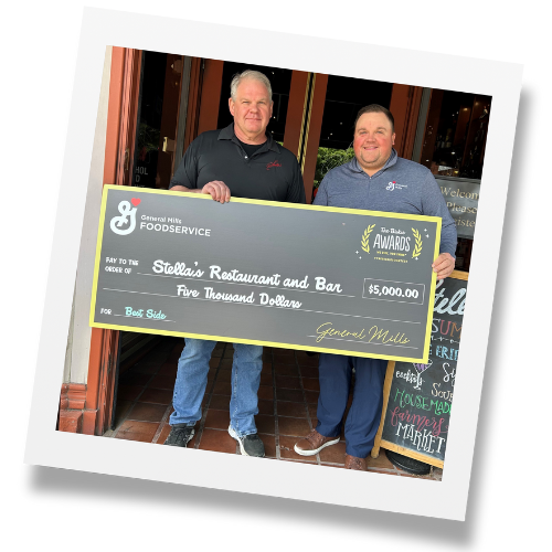 Man stands on front steps of restaurant holding large black check from General Mills Foodservice awarding $5,000.