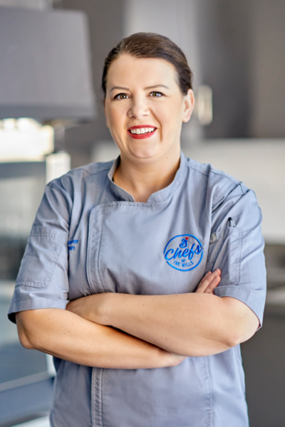 Chef Heather Headshot in a Chef Coat smiling